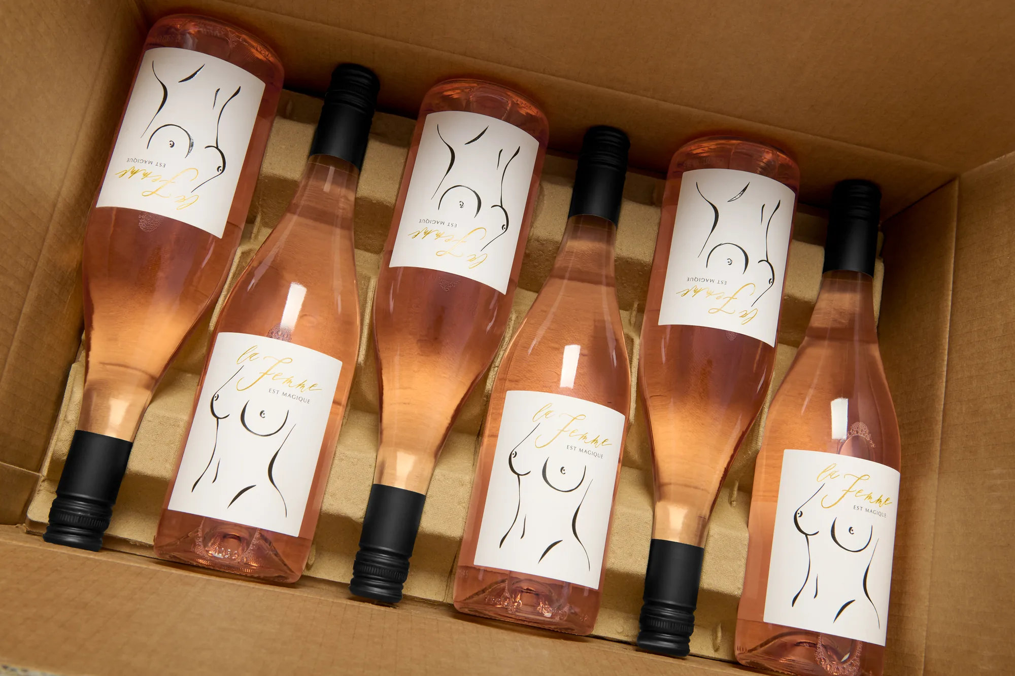 Bottle of La Femme est Magique rosé nestled in its branded gift box, Christmas presentation